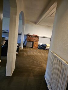 A freshly vacuumed carpeted hallway with distinct lines, demonstrating professional house cleaning by Way Too Bright Services LLC in Rockford, IL.