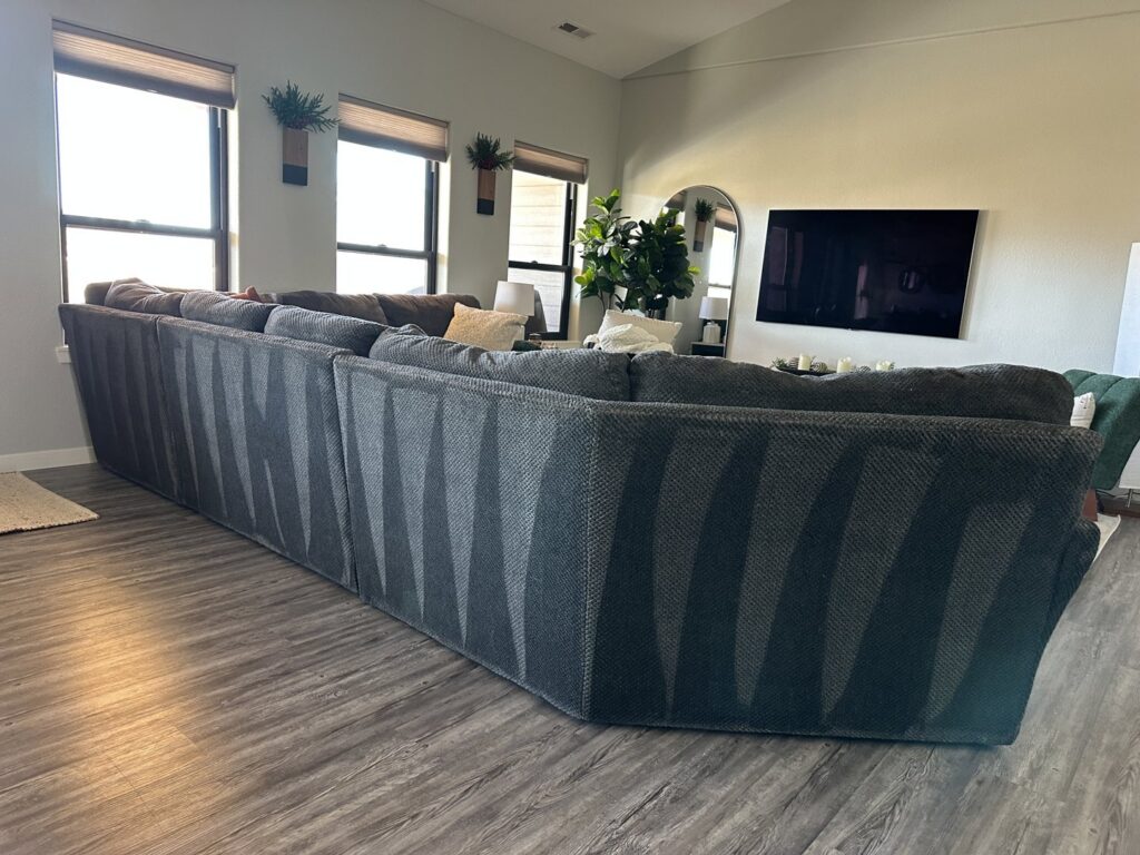 A large sectional sofa with clear vacuum lines, indicating a freshly cleaned surface by Cleaning Quality in Sturgis, SD