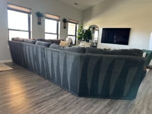 A large sectional sofa with clear vacuum lines, indicating a freshly cleaned surface by Cleaning Quality in Sturgis, SD