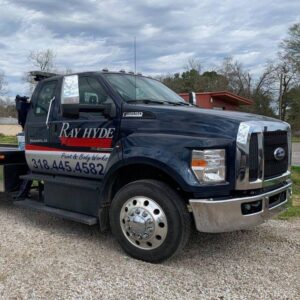 Front-side view of a Ray Hyde Paint & Body Works tow truck ready for service in Alexandria, LA.