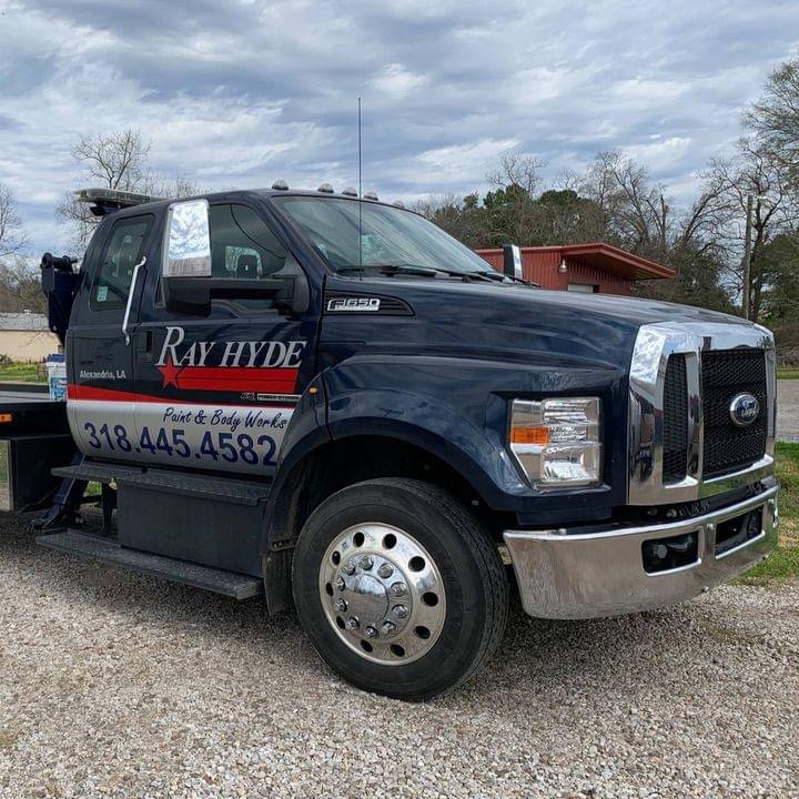 Front-side view of a Ray Hyde Paint & Body Works tow truck ready for service in Alexandria, LA.