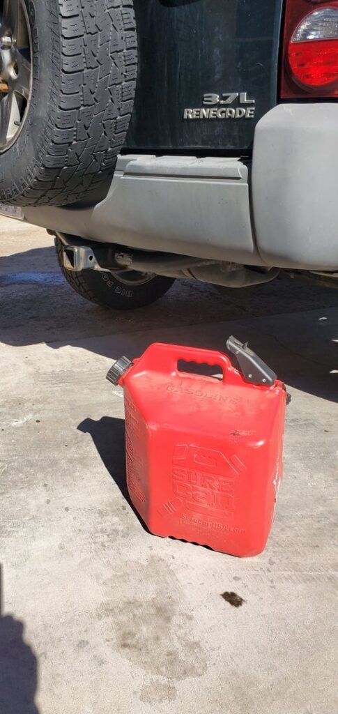 A red gas can on the ground, ready for a fuel delivery service by Liberty Auto Rescue in Colorado Springs, CO.