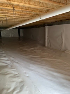 A fully encapsulated crawlspace with white vapor barrier, demonstrating water damage prevention by Allied Foundation & Crawlspace Solutions in Decatur, AL.
