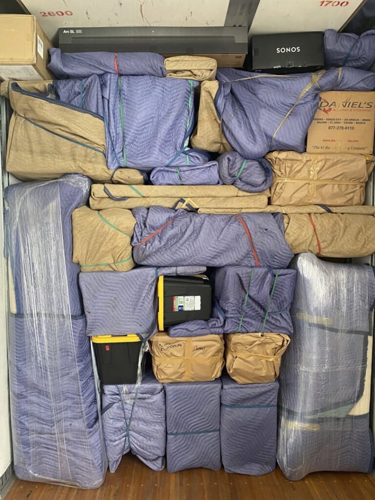 A moving truck fully packed with furniture and items wrapped in protective blankets and secured by Moving Marvels in Tucson, AZ.