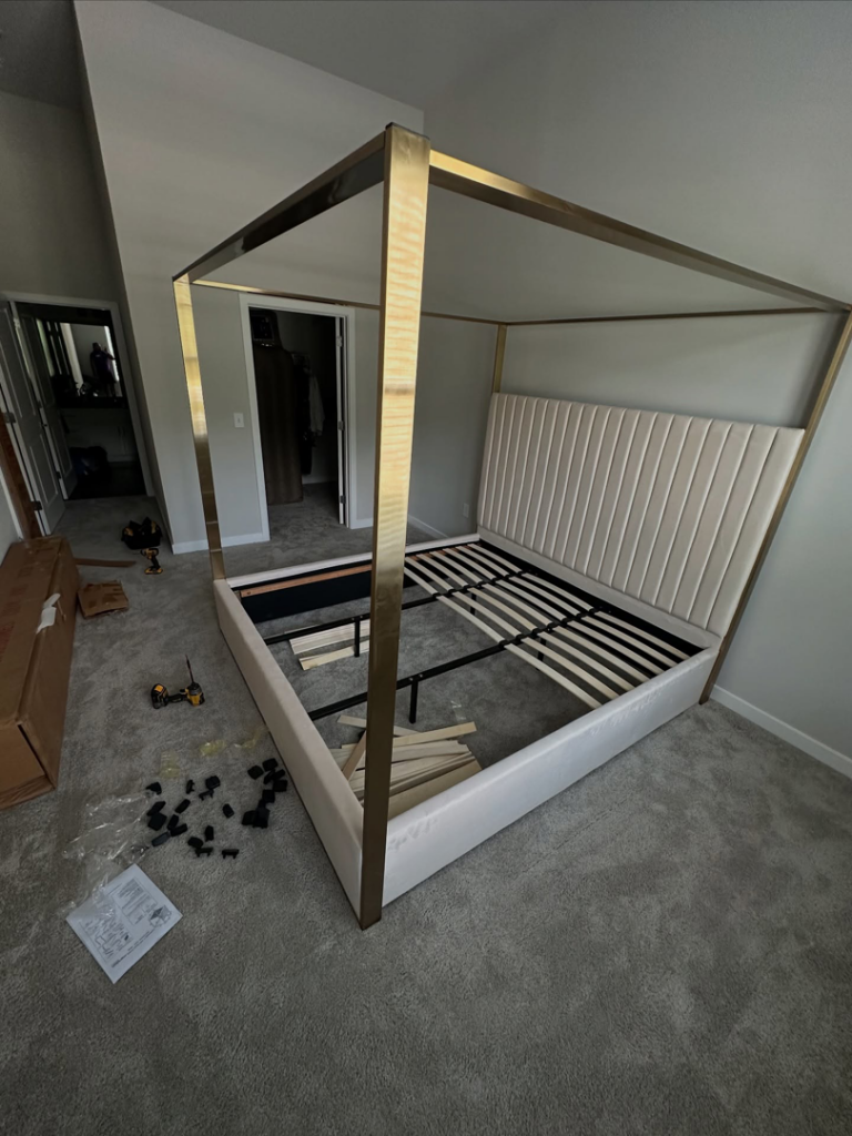 A partially assembled bed frame with tools and parts on the floor, showing furniture assembly by Mr Capitol Services llc in Laurel, MD.