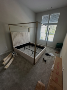 A partially assembled bed frame with tools and packaging, showcasing furniture assembly service by Mr Capitol Services llc in Laurel, MD.