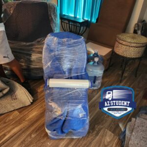 Various pieces of furniture, including a chair and small table, carefully wrapped for moving by Az Student Movers in Scottsdale, AZ