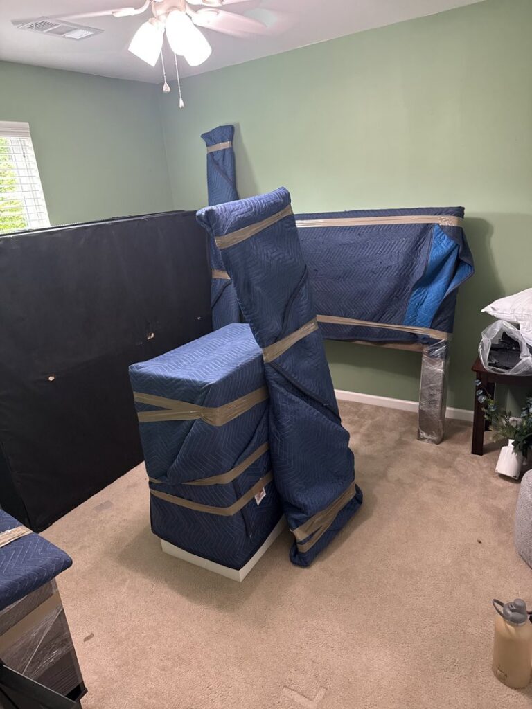 Furniture carefully wrapped in blue moving blankets by Family Movers 615 LLC in Goodlettsville, TN.