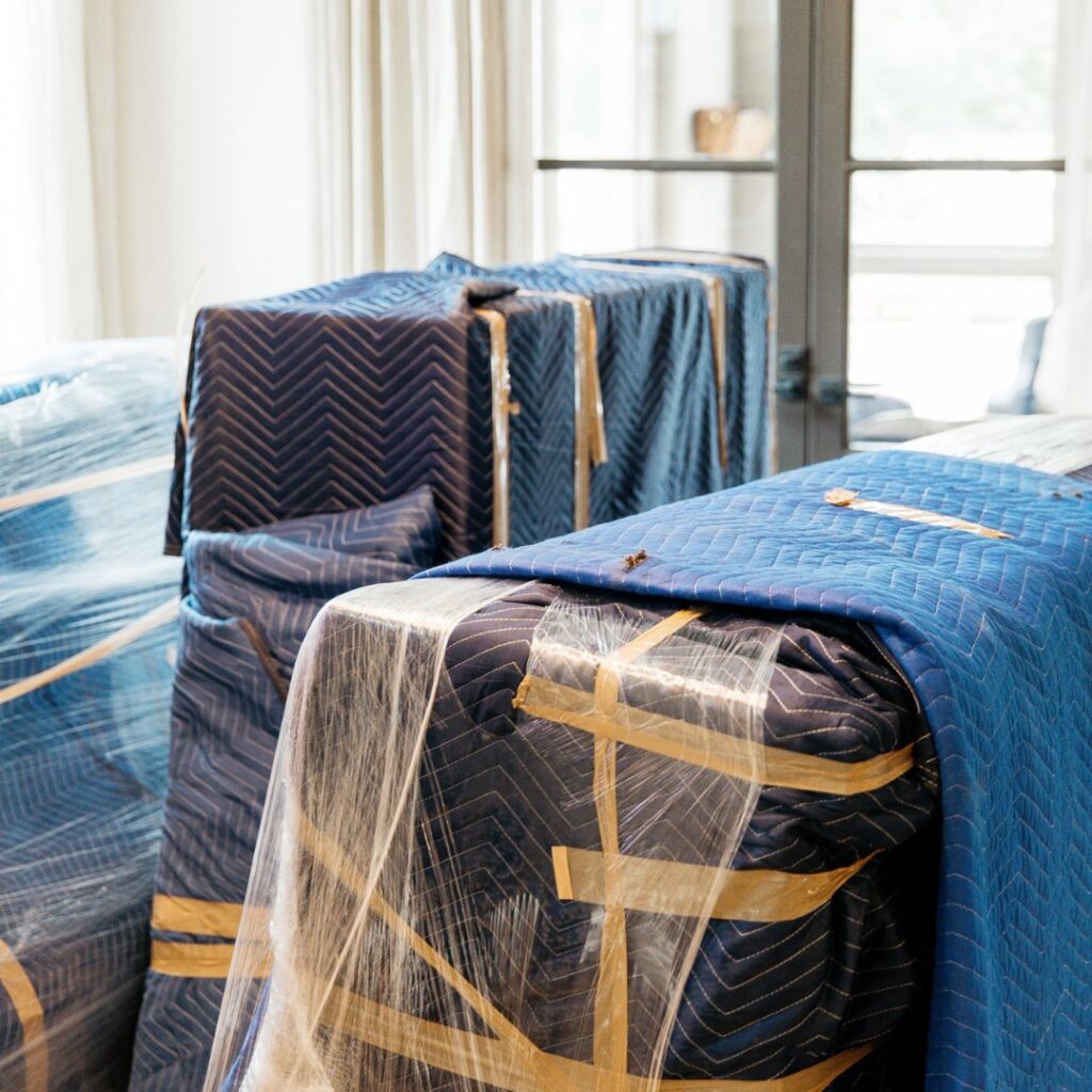 Furniture carefully wrapped in blue moving blankets and plastic wrap by The Armstrong Company in Huntsville, AL.
