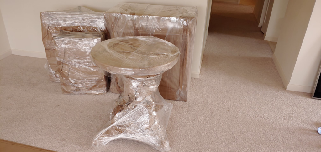 Household furniture carefully wrapped in plastic by Prime Moving Center, ready for transport in Pittsburgh, PA.