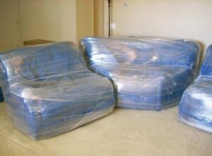 Residential furniture carefully wrapped in plastic for protection during a move by Moving Pros LLC in Surprise, AZ.