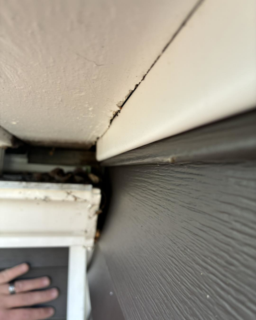 A close-up of a gap between a gutter and fascia/soffit, a common cause of water damage, by Barbera Home Improvement in Parma, OH.