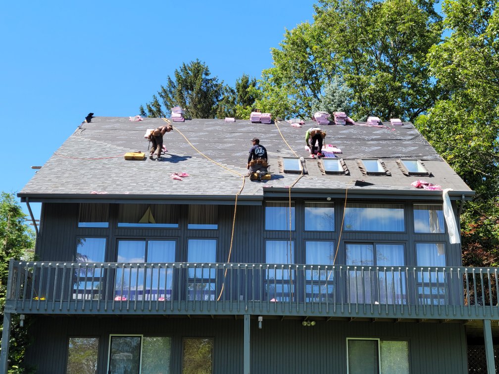 A garage under construction with red sheathing, prepared for siding installation by KC Entities Roofing and Siding in Mechanicville, NY
