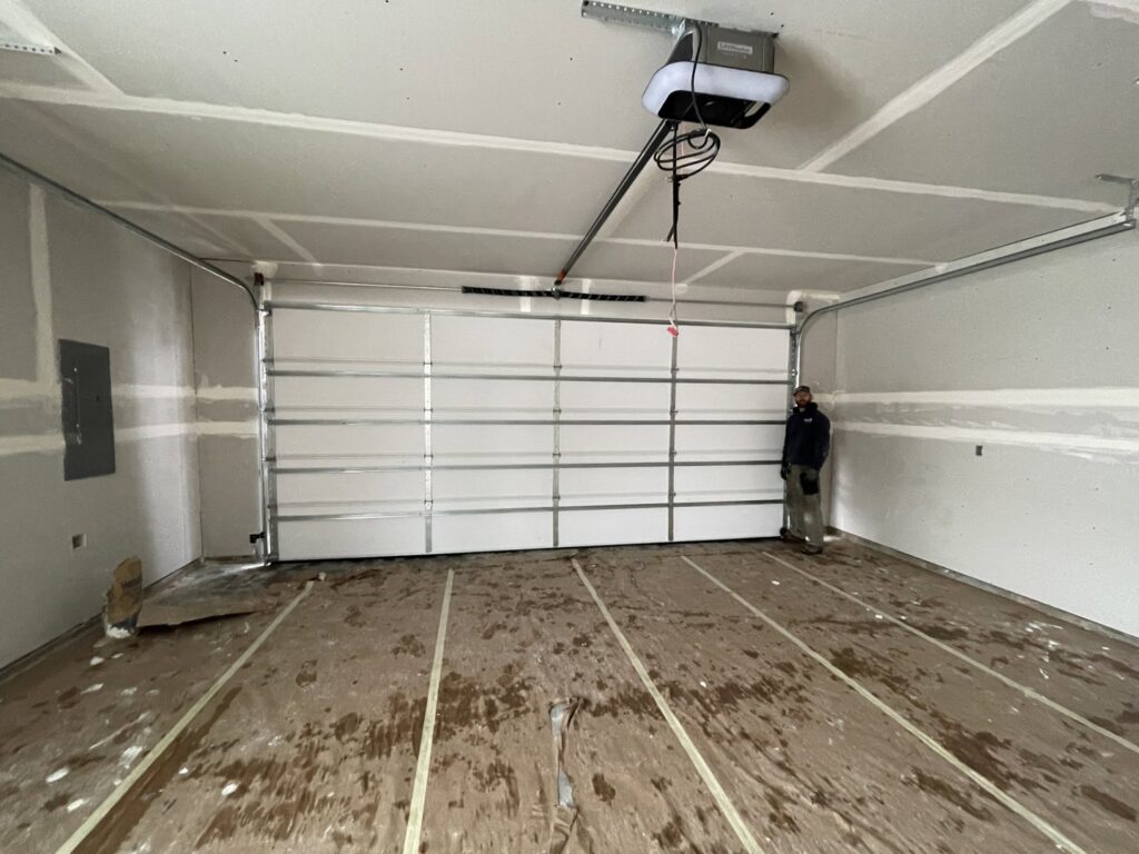 A newly installed garage door and opener inside a residential garage, showcasing work by ProLift Garage Doors of Canyon County in Nampa, ID.