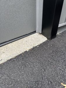 Close-up of a garage door bottom seal and concrete by Mascolo Overhead Doors & Maintenance in Brookfield, CT.