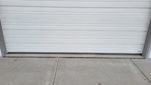 A close-up of the bottom of a garage door showing the weather seal, indicating quality installation by Overhead Door Company of Albuquerque in Albuquerque, NM.