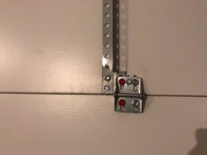 Close-up of a garage door hinge and roller assembly, showing components serviced by Sandia Garage Door Repair in Albuquerque, NM