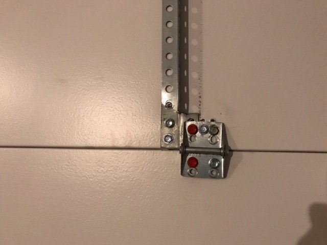 Close-up of a garage door hinge and roller assembly, showing components serviced by Sandia Garage Door Repair in Albuquerque, NM