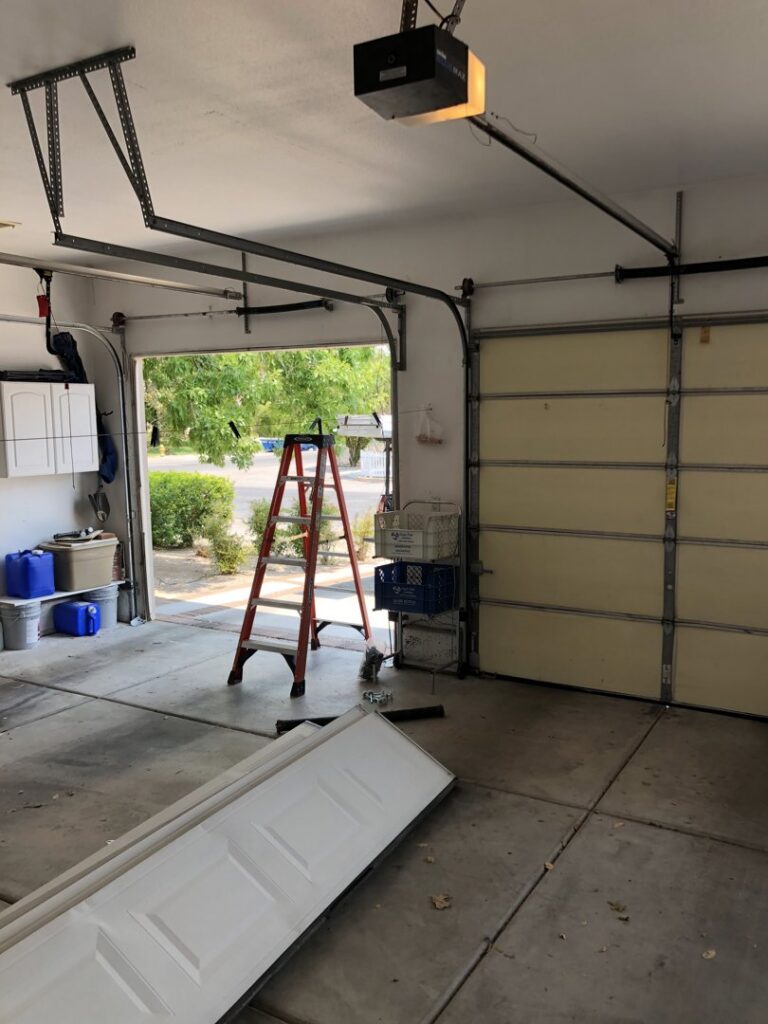 Garage door installation in progress with new panels and a ladder by Valley Overhead Door in Las Vegas, NV.