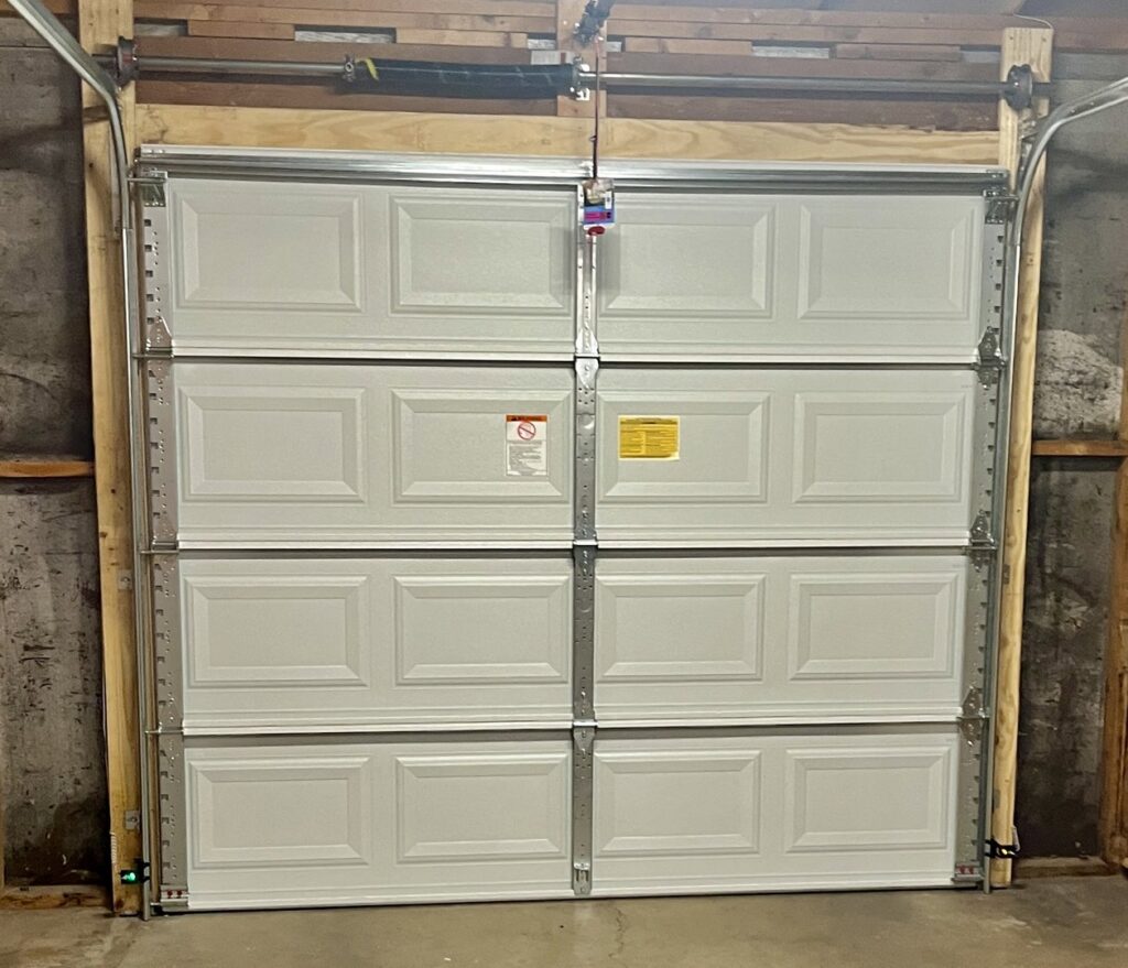 Interior view of a new white panel garage door installation by Spartan Garage Doors and More in Albuquerque, NM.