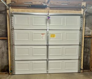 Interior view of a new white panel garage door installation by Spartan Garage Doors and More in Albuquerque, NM.