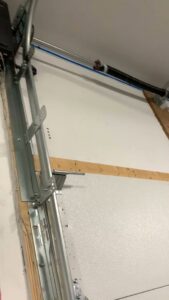 The interior mechanism of a garage door, including tracks, springs, and panels, serviced by ProLift Garage Doors of Canyon County in Nampa, ID.