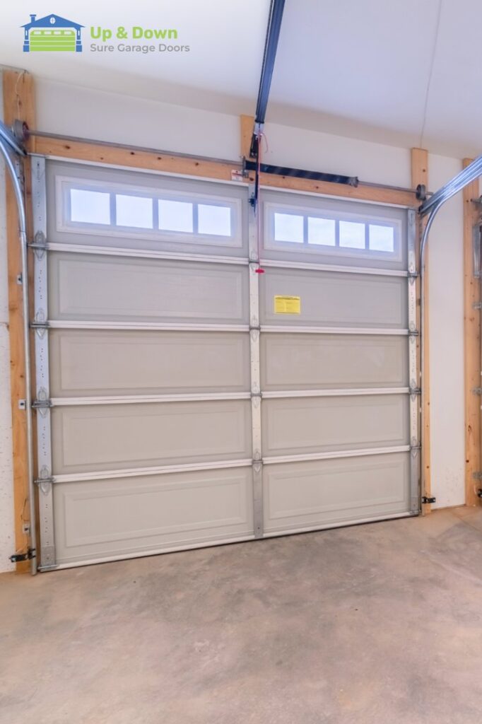 A garage door keypad installed on a brick wall by Up & Down Garage Doors New Haven in New Haven, CT