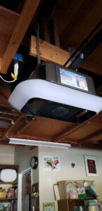A newly installed garage door opener on a residential ceiling, showcasing the work of Carmichael Garage Door in Carmichael, CA.