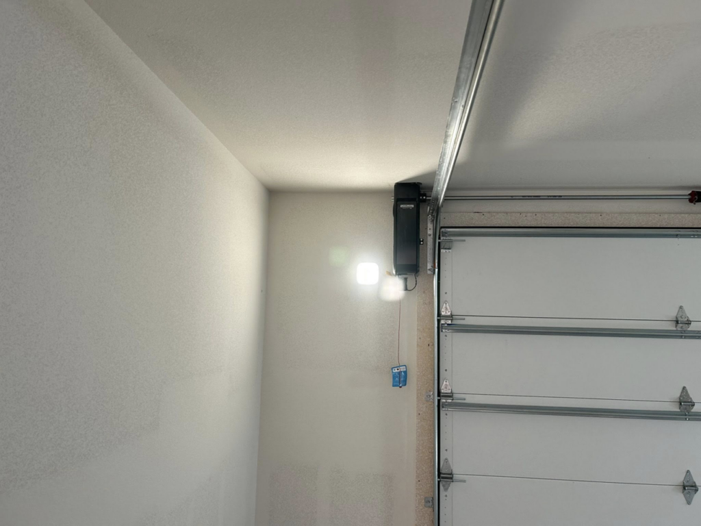 A newly installed garage door opener and track system by Complete Garage Solutions NWA in Centerton, AR.