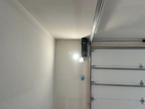 A newly installed garage door opener and track system by Complete Garage Solutions NWA in Centerton, AR.