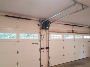 Interior view of a garage with installed garage doors and opener system by Garage Doors & More in Bentonville, AR