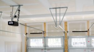 Close-up of garage door opener, springs, and tracks, showing repair or installation by 74 Garage Door Company in Lake Park, FL