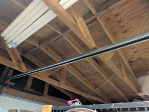 The track system for a garage door opener installed in a residential garage by Overhead Door Company of Santa Fe in Santa Fe, NM.