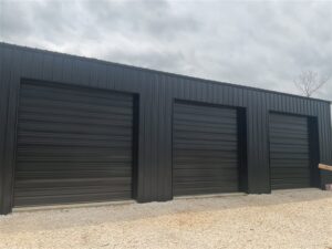 Garage door panels and components laid out for installation or removal by Fayetteville Garage Door Co. in Fayetteville, AR
