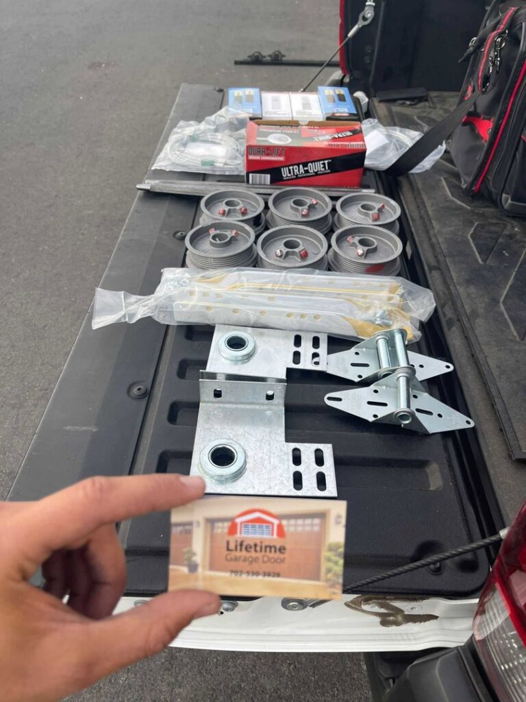 Various garage door parts and tools laid out in a truck bed, ready for a job by Lifetime Garage Door in Las Vegas, NV.