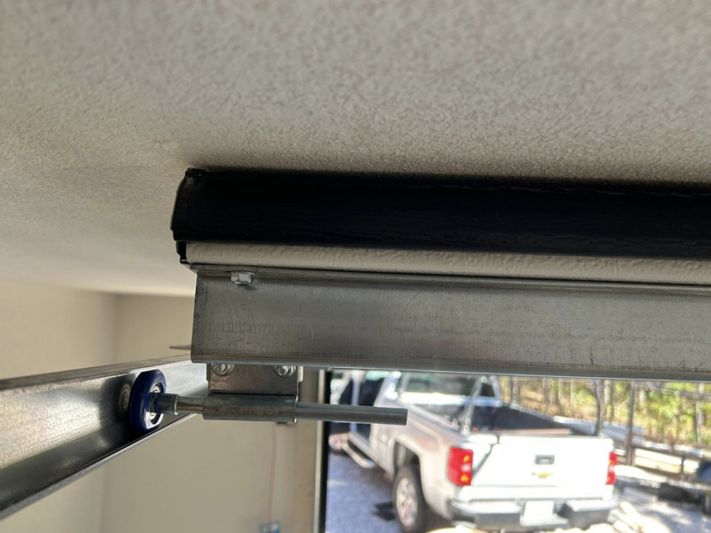 Close-up of a garage door roller and track system installed by Complete Garage Solutions NWA in Centerton, AR.