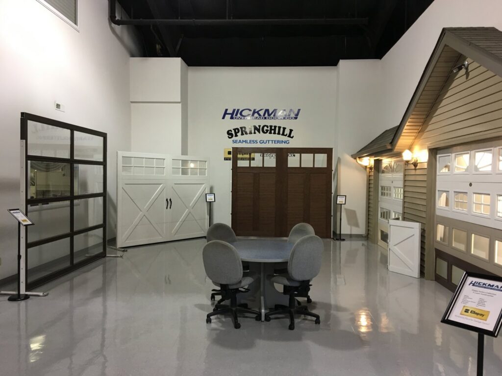 A showroom display featuring various garage door models at Hickman Overhead Door in Milford, DE.