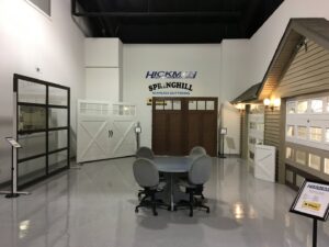 A showroom display featuring various garage door models at Hickman Overhead Door in Milford, DE.