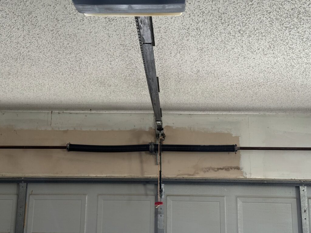 Close-up of a garage door spring system, indicating repair or maintenance service by Garage Doors & More in Bentonville, AR