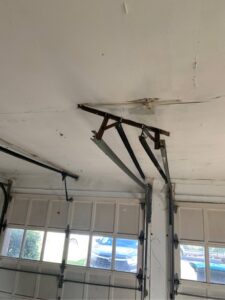 An interior view of garage door springs and tracks during an inspection by Delaware Express Garage Door Service in Wilmington, DE