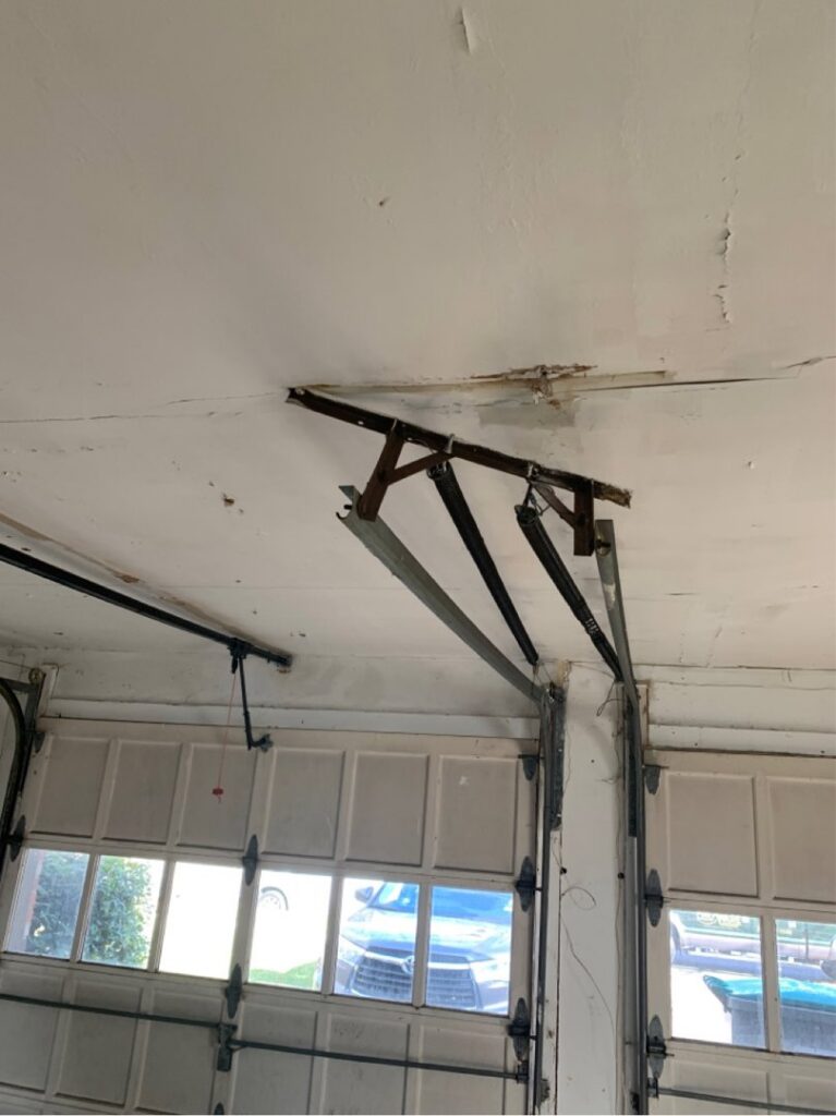 An interior view of garage door springs and tracks during an inspection by Delaware Express Garage Door Service in Wilmington, DE