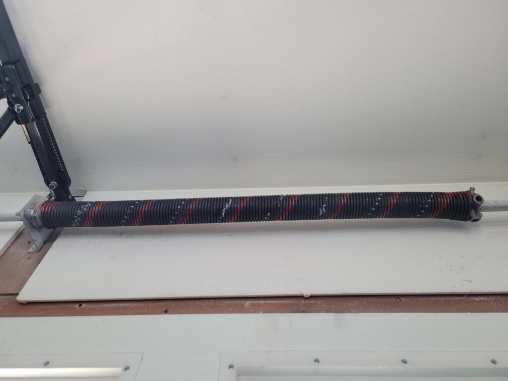 Close-up of a garage door torsion spring assembly, ready for repair or replacement by Klondike Door Service in Fairbanks, AK