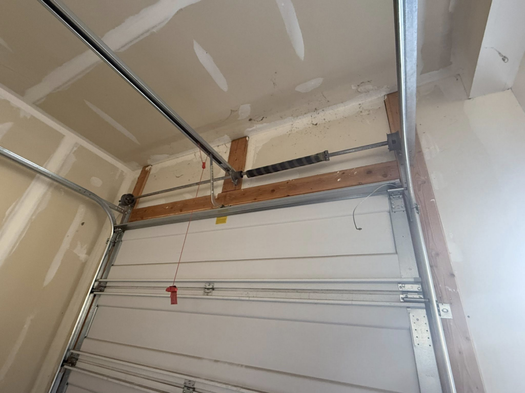 An overhead view of a garage door torsion spring system and track installed by A-1 Garage Door Repair in Syracuse, UT.