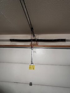 A close-up view of a garage door torsion spring system, showcasing installation or maintenance by Overhead Door Company of Albuquerque in Albuquerque, NM.