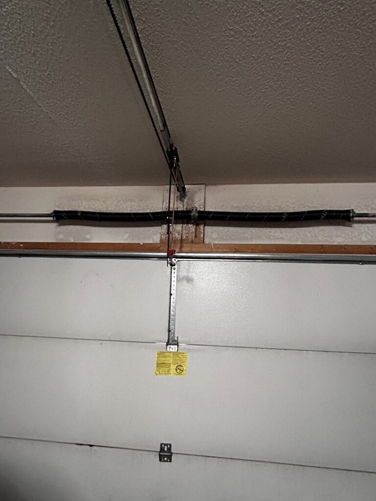 A close-up view of a garage door torsion spring system, showcasing installation or maintenance by Overhead Door Company of Albuquerque in Albuquerque, NM.