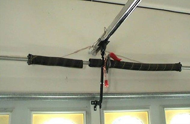 A close-up of garage door torsion springs and bar, components serviced by Central Garage Door Service in Kapolei, HI.