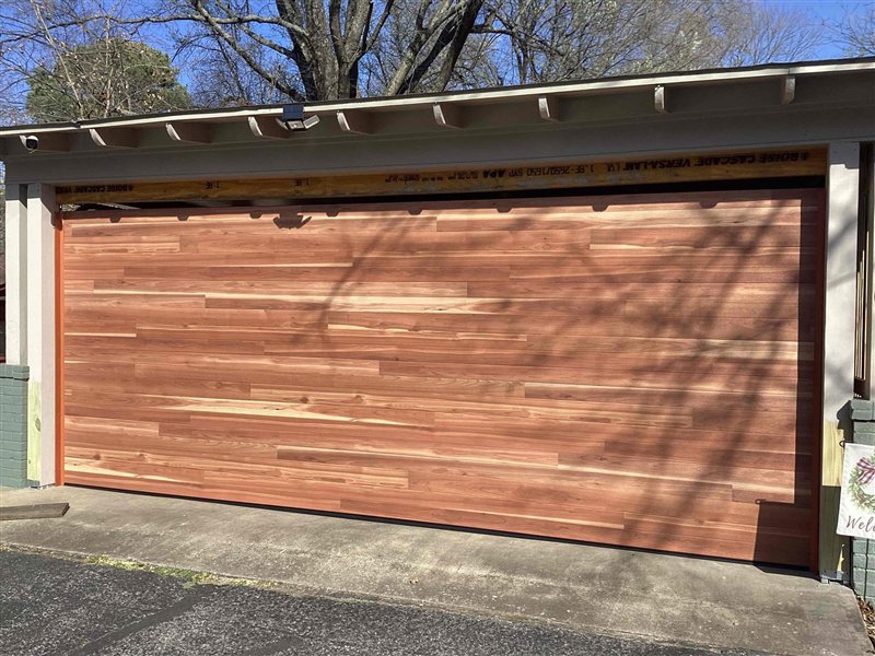 Interior view of a garage door showing torsion springs and tracks, serviced by Fayetteville Garage Door Co. in Fayetteville, AR