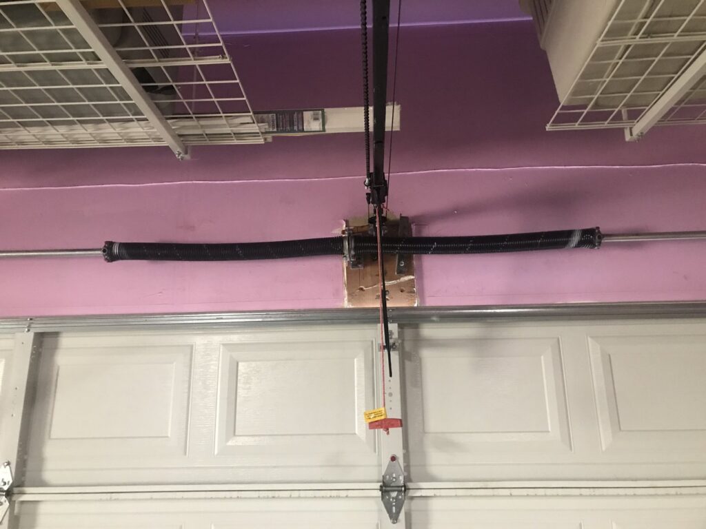 A close-up of garage door torsion springs, a common repair or replacement service offered by Delta Garage Door in Millcreek, UT.