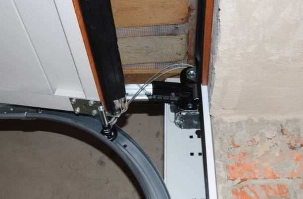 Close-up of a garage door track, roller, and internal mechanism serviced by Full Circle Overhead Door in Wilmington, DE.