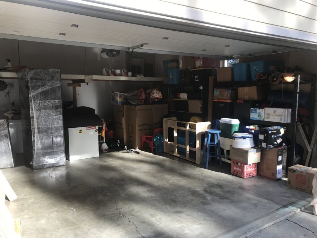 A garage filled with packed moving boxes and wrapped items, ready for transport by Emerald Moving & Storage, Inc. in Eugene, OR.